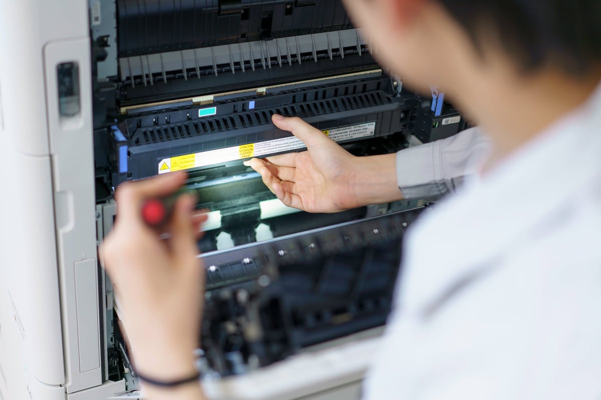 Technician servicing a photocopier
